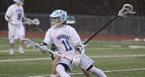 Junior attack/mid Jimmy Cosolito (11) fights through a stick-check and moves the ball up the wing.