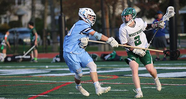 Medfield’s Derek Gemski (20) defends against Westwood’s Conor Donohue (2) on a cut from X. Photos by Denise DePiero