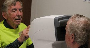 Jack Mulhall operates the glaucoma testing machine in the Lions Eyemobile.