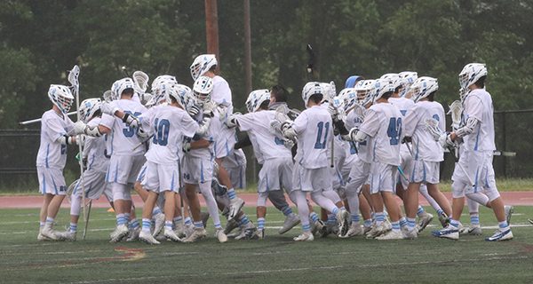 The Medfield High boys varsity lacrosse team celebrates following their 9-7 win over Concord-Carlisle on Thursday to claim the Division II Central/East title. Photos by Denise DePiero.