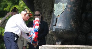WWII Veteran George Yered places a wreath at the memorial.