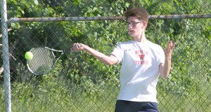 Freshman Jake Lowenstein handles a high forehand during a long baseline rally. Photos by James Kinneen 