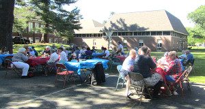 Attendees filled over a dozen tables as they socialized and ate together.