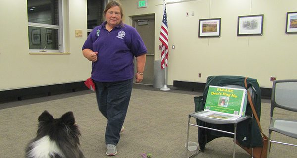 Cathy Acampora and her dog, Merida, demonstrate the correct way to approach a dog.