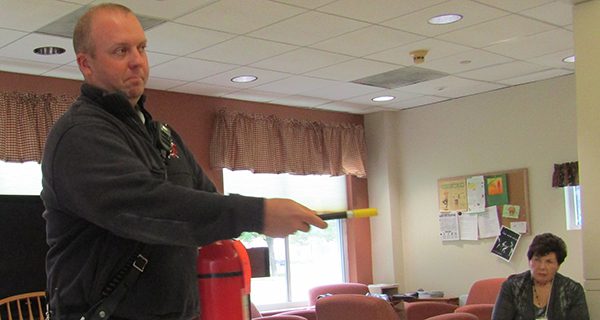Andy Mahan shows the proper technique for using a fire extinguisher.