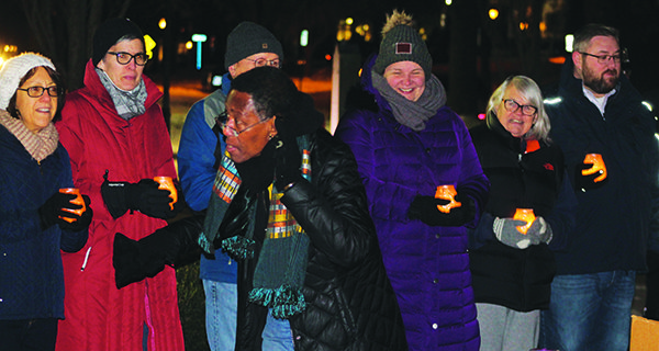 Despite the cold, many people came out to the MLK Day candlelight vigil and sang with Adrienne Williams.