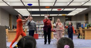 Plate spinners perform in library.