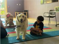 Children practice reading with pups