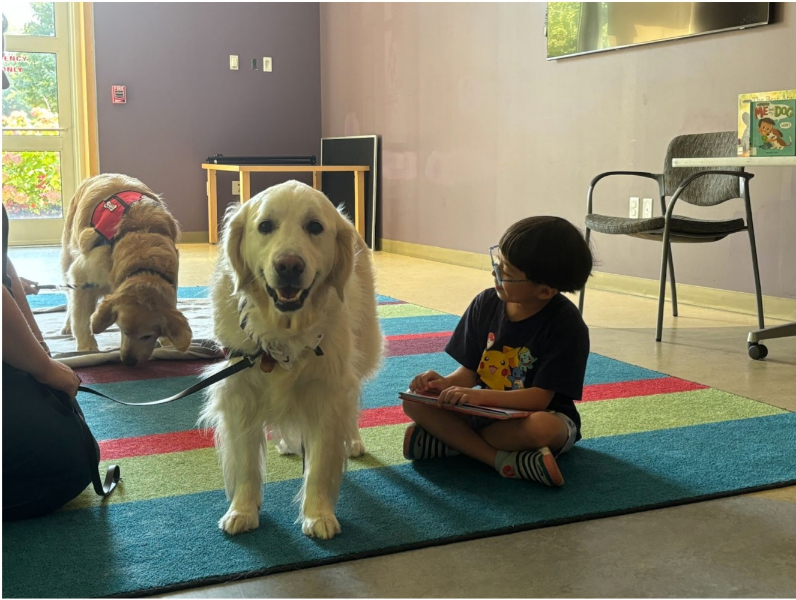 Children practice reading with pups