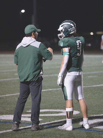 Narwut Kam talks with coach Nathan Costello