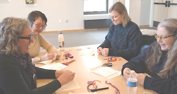 Stitchers of all levels learn in embroidery class at Sherborn Library