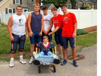 WHS Football Team brings smiles to young fan