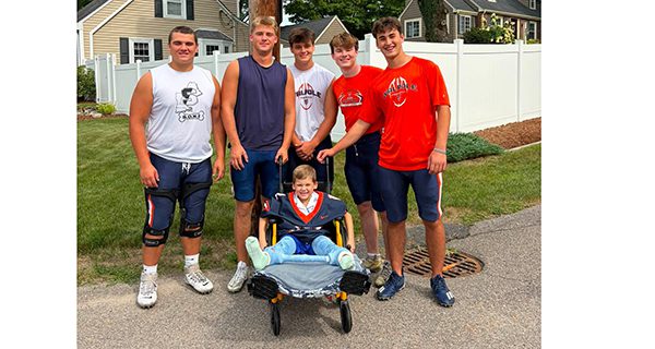 WHS Football Team brings smiles to young fan